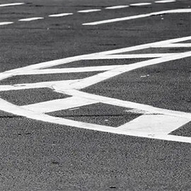 A street sign painted on the side of a road.