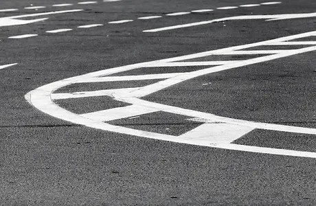 A street with white lines and numbers on it.